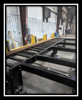 Heavy-Duty Powered Roller Conveyors 	With Stock Arms and Vertical Guide Rollers Also, Custom Drop-Down Table For A Free Pathway